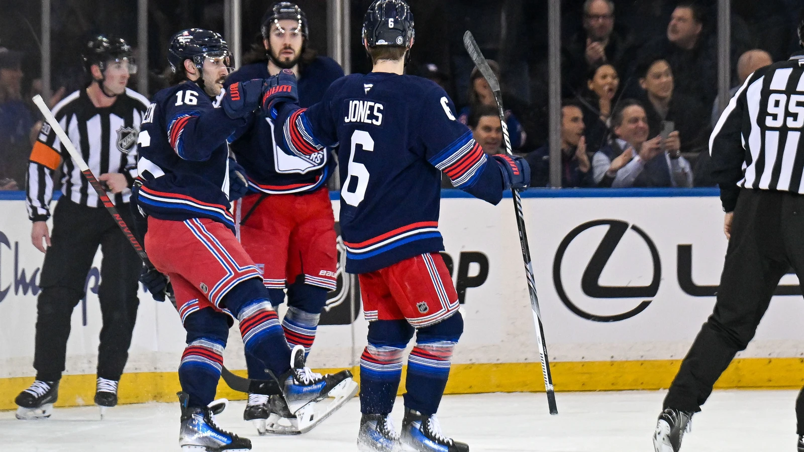 Zac Jones joins Vincent Trocheck and Mika Zibanejad in a New York Rangers goal celebration at Madison Square Garden on April 9, 2025. File photo.