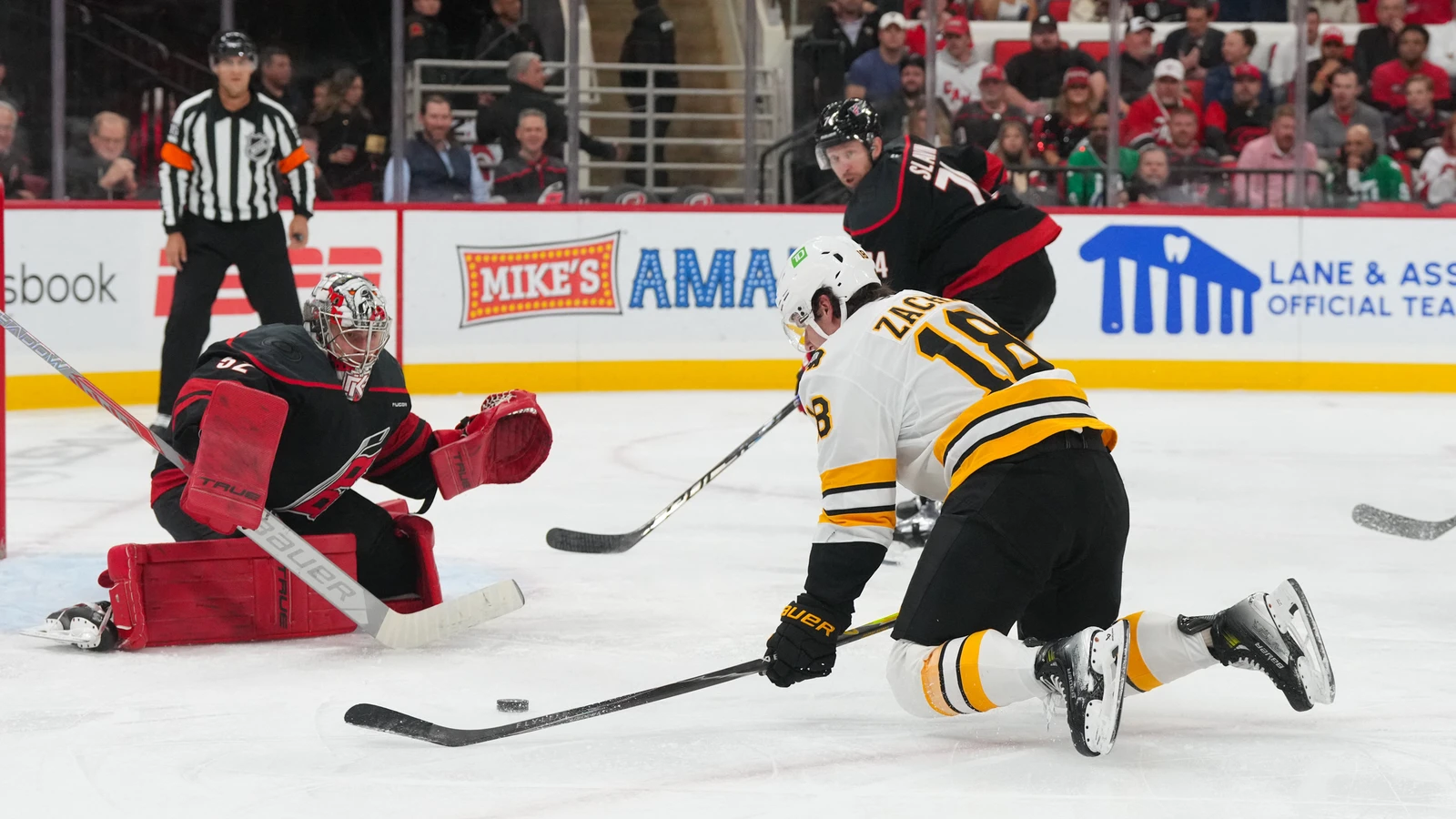 Carolina Hurricanes goaltender Pyotr Kochetkov guards the net as Boston Bruins centre Pavel Zacha reaches for the puck at Lenovo Center.