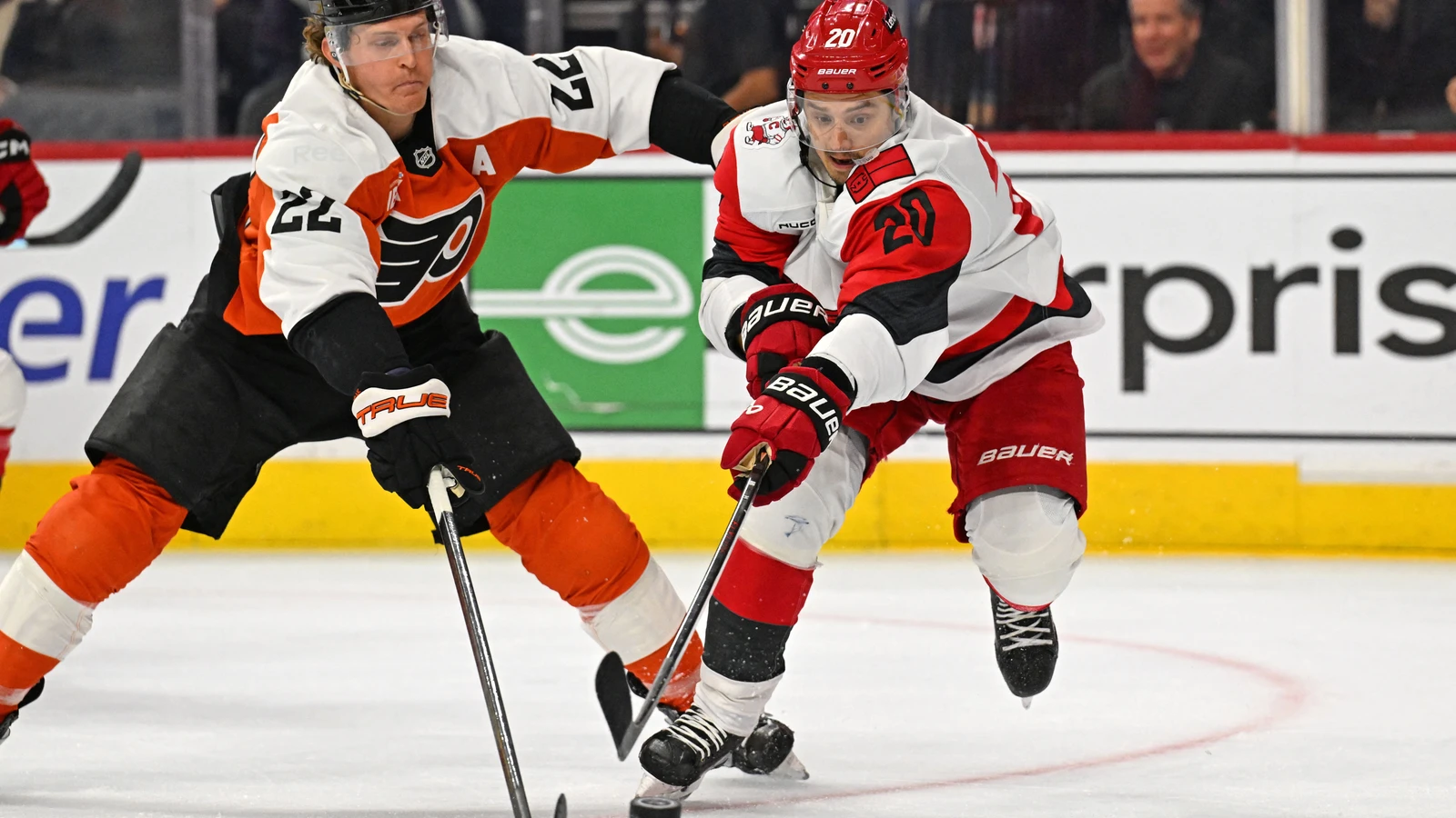Carolina Hurricanes centre Sebastian Aho battles Philadelphia Flyers centre Christian Dvorak for the puck at Xfinity Mobile Arena.