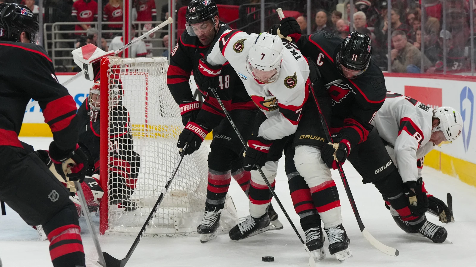 File photo: Brady Tkachuk (7), then captain of the Ottawa Senators, battles for the puck against Carolina Hurricanes players during an Apr. 20, 2026 playoff game in Raleigh.