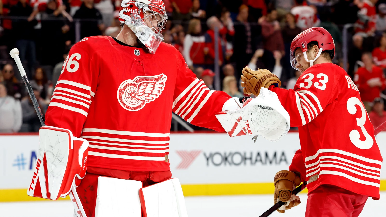 Detroit Red Wings forward Viktor Arvidsson receives congratulations from goaltender John Gibson after scoring against the Chicago Blackhawks.
