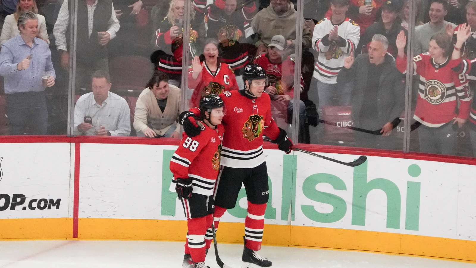 Connor Bedard celebrates with Louis Crevier during an April 2026 Blackhawks game. File photo.