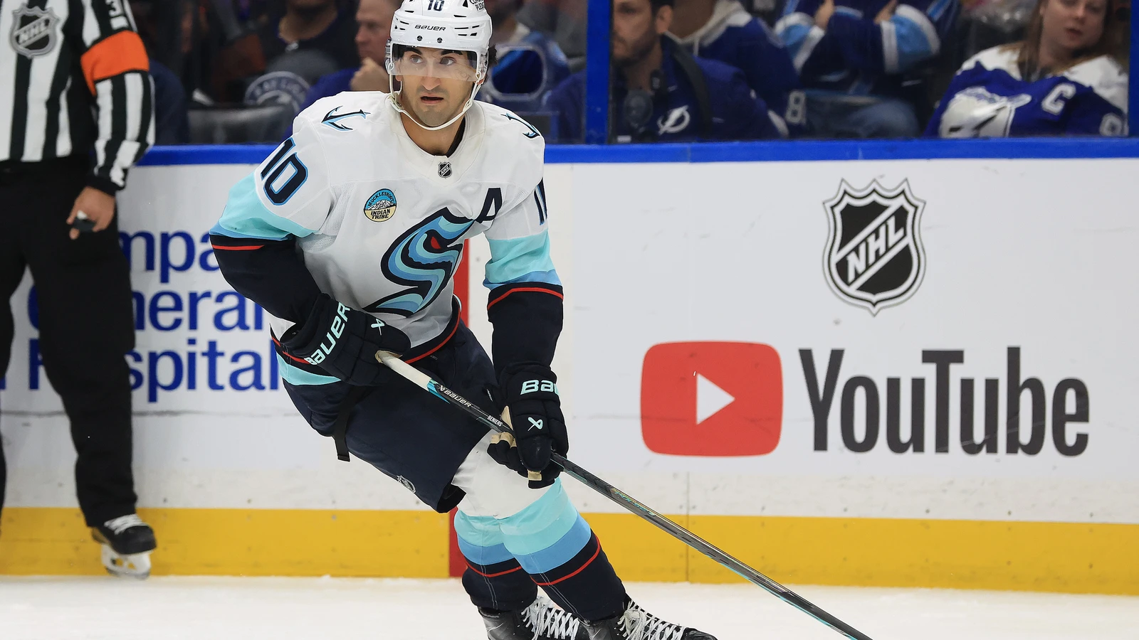 Seattle Kraken centre Matty Beniers skates with the puck against the Tampa Bay Lightning at Benchmark International Arena on Oct. 15, 2026.