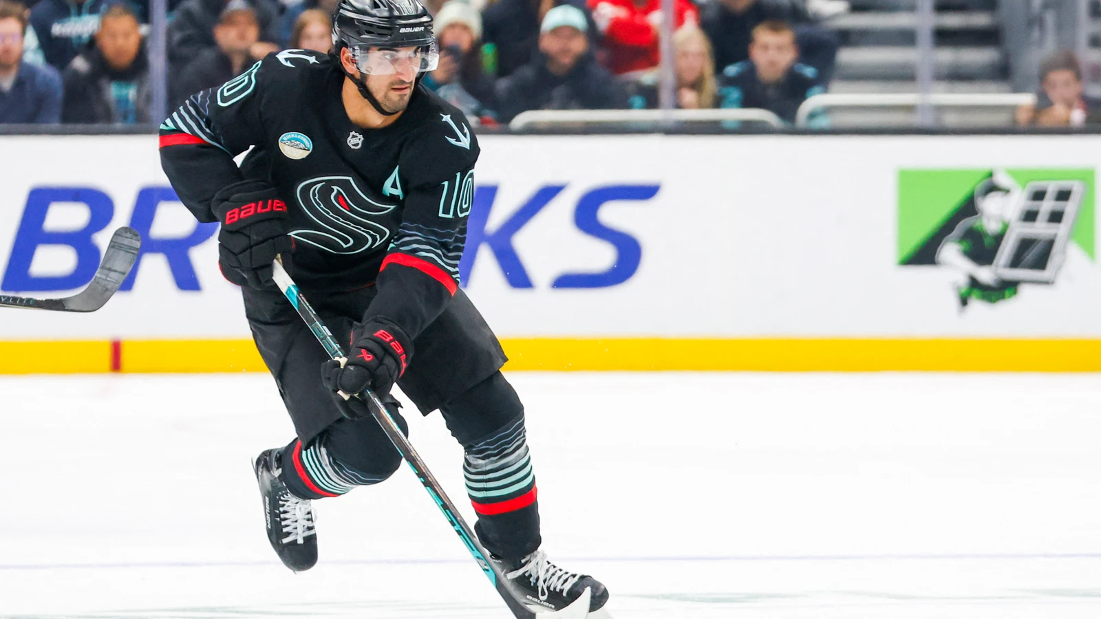File photo: Seattle Kraken centre Matty Beniers skates with the puck against the Detroit Red Wings at Climate Pledge Arena.