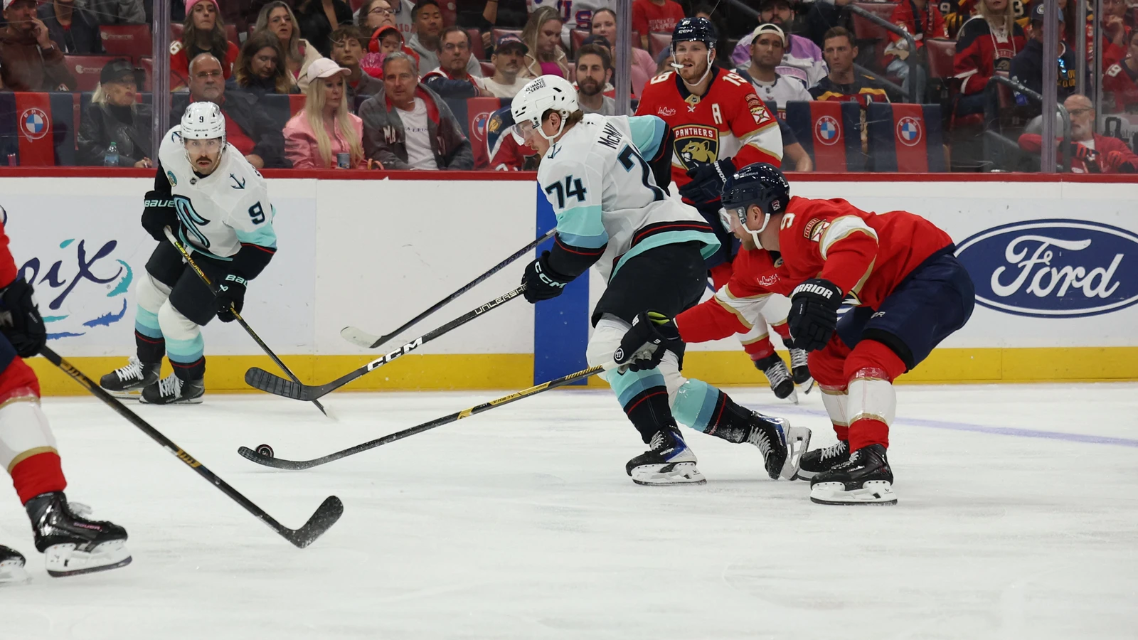 Florida Panthers centre Sam Bennett battles for the puck with Seattle Kraken centre Bobby McMann at Amerant Bank Arena.