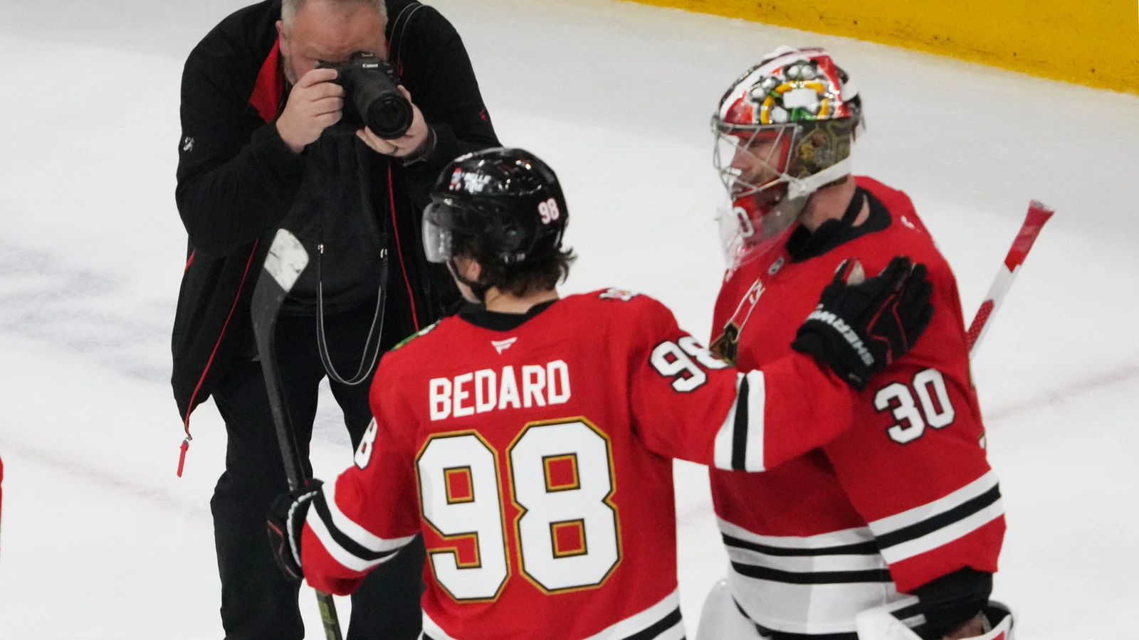 Connor Bedard celebrates a Blackhawks win with goaltender Spencer Knight in April 2026.