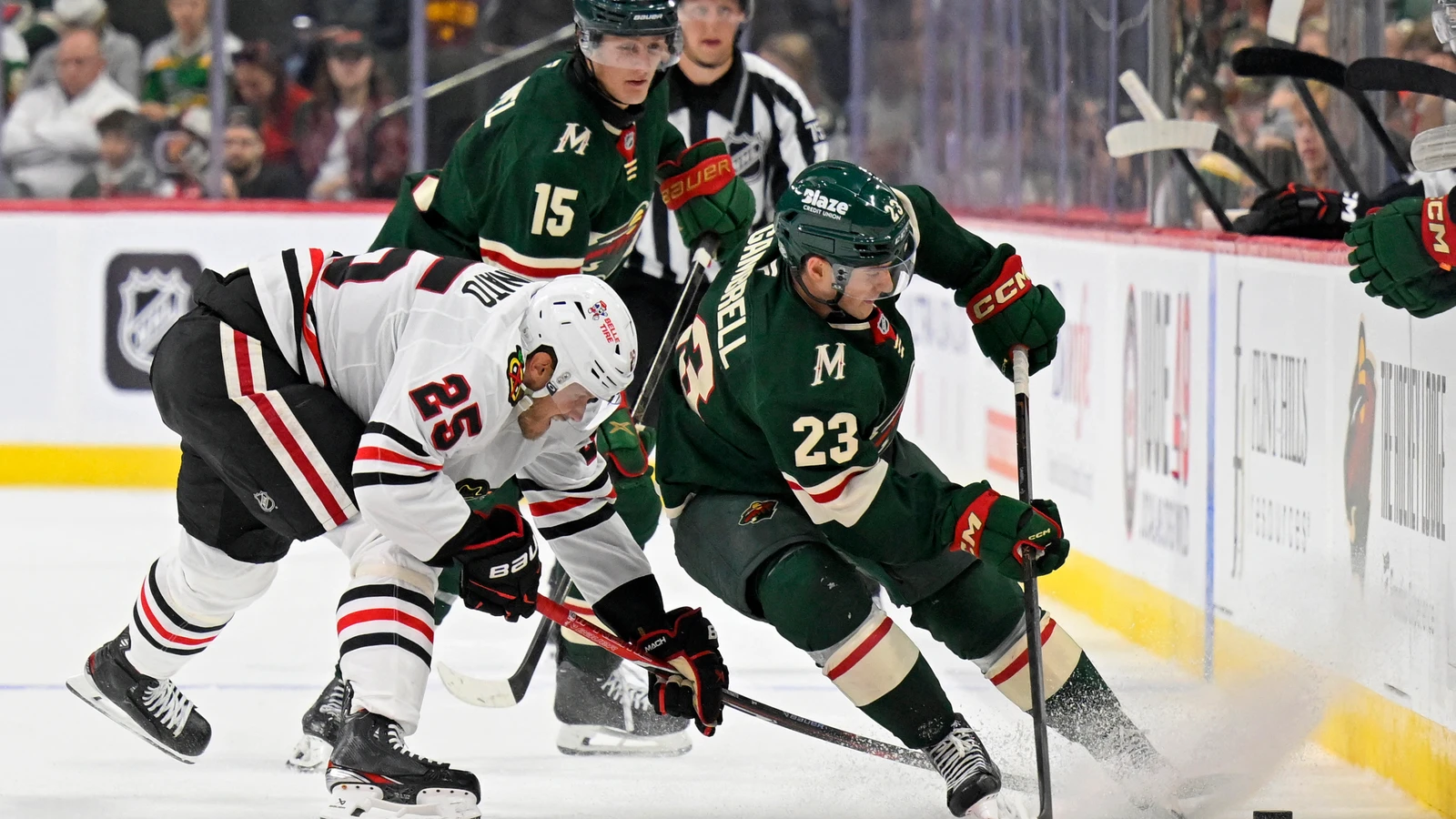 File photo: Chicago Blackhawks forward Dominic Toninato battles for the puck with Minnesota Wild forward Dylan Gambrell.