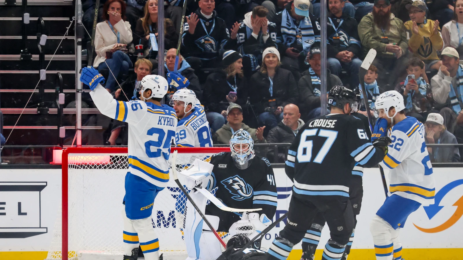 File photo: Pavel Buchnevich (89) celebrates with St. Louis Blues teammates beside the Utah Mammoth net.