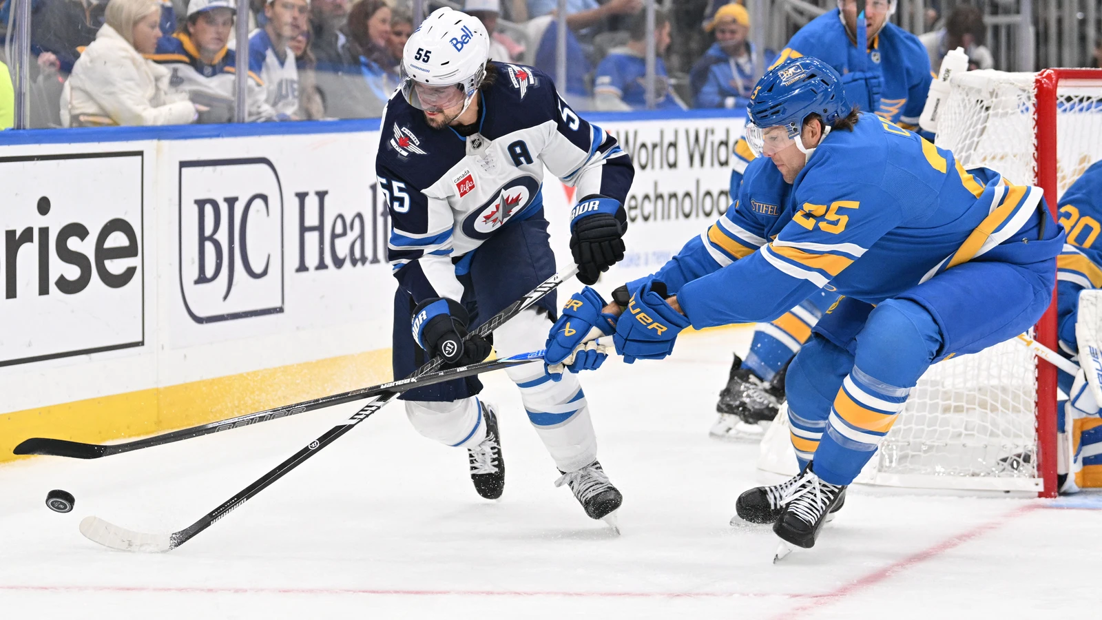 File photo: St. Louis Blues defenceman Brandon Carlo battles Winnipeg Jets centre Mark Scheifele for the puck at Enterprise Center.
