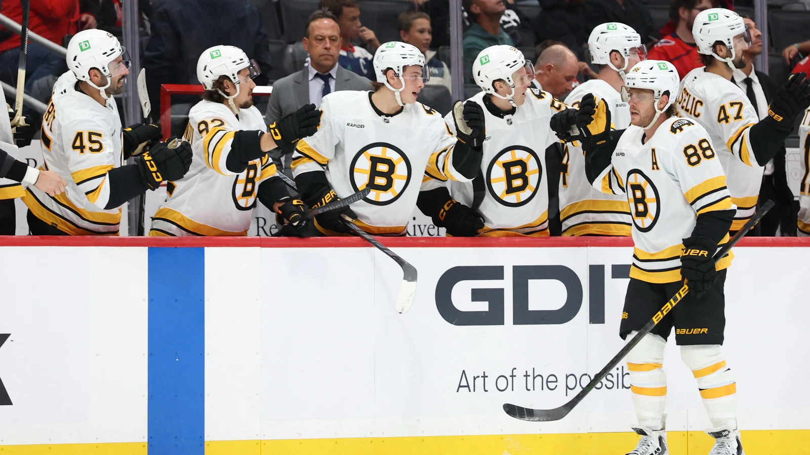 File photo: David Pastrnak, wearing No. 88 for the Boston Bruins, celebrates a goal with teammates at the boards during a September 25, 2026 game in Washington.