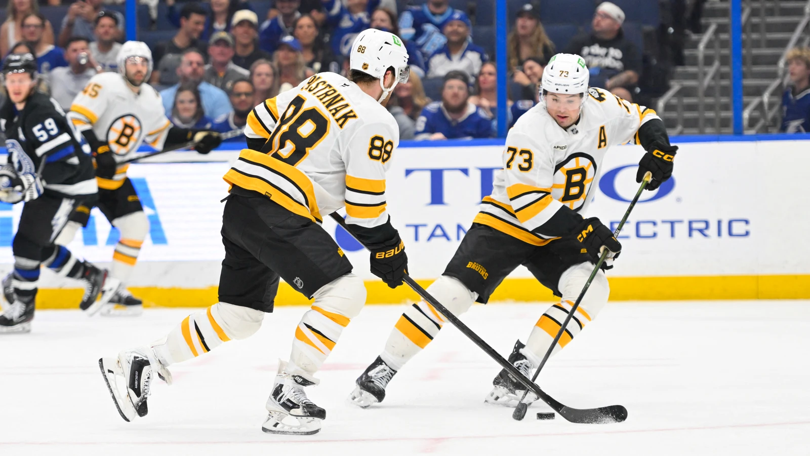 David Pastrnak and Charlie McAvoy skate for Boston during an April 2026 game. File photo.