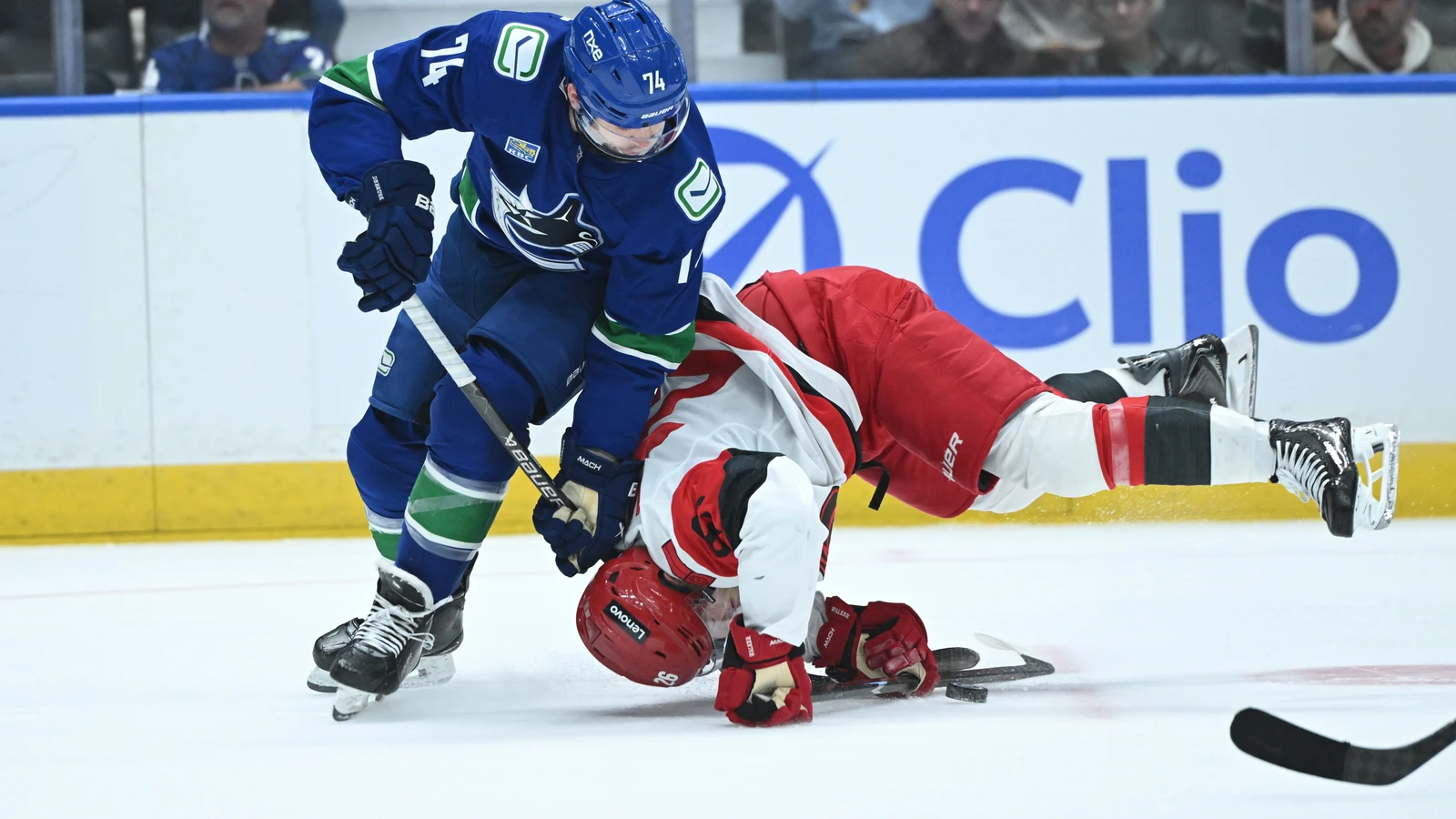 File photo: Vancouver Canucks forward Jake DeBrusk checks a Carolina Hurricanes player at Rogers Arena.