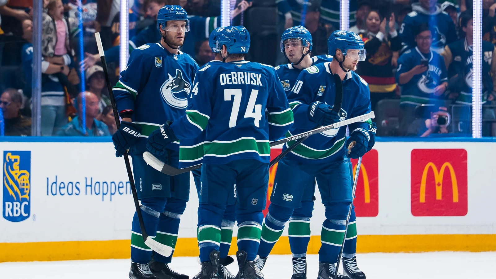 File photo: Vancouver Canucks forward Jake DeBrusk, wearing number 74, celebrates a goal with teammates at Rogers Arena.