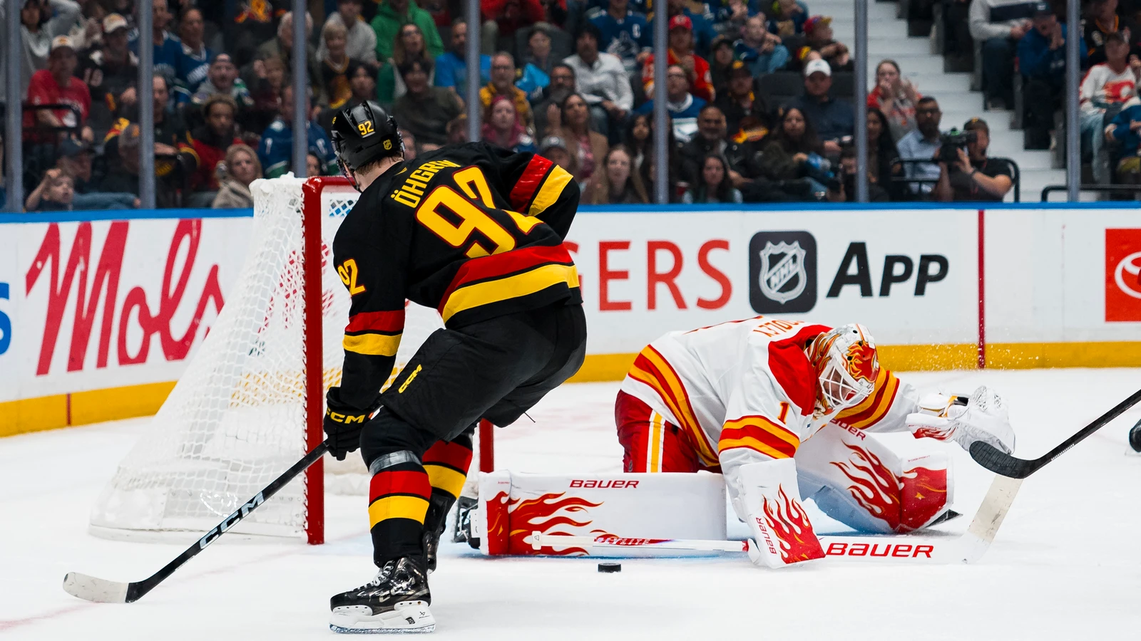 Vancouver Canucks forward Liam Ohgren shoots towards Calgary Flames goaltender Devin Cooley at Rogers Arena.