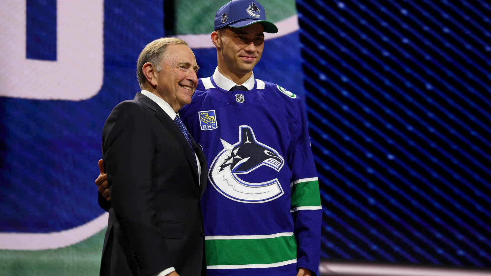 Adam Novotný stands with Gary Bettman after Vancouver selects him 24th overall at the NHL Draft on June 26, 2026. File photo.