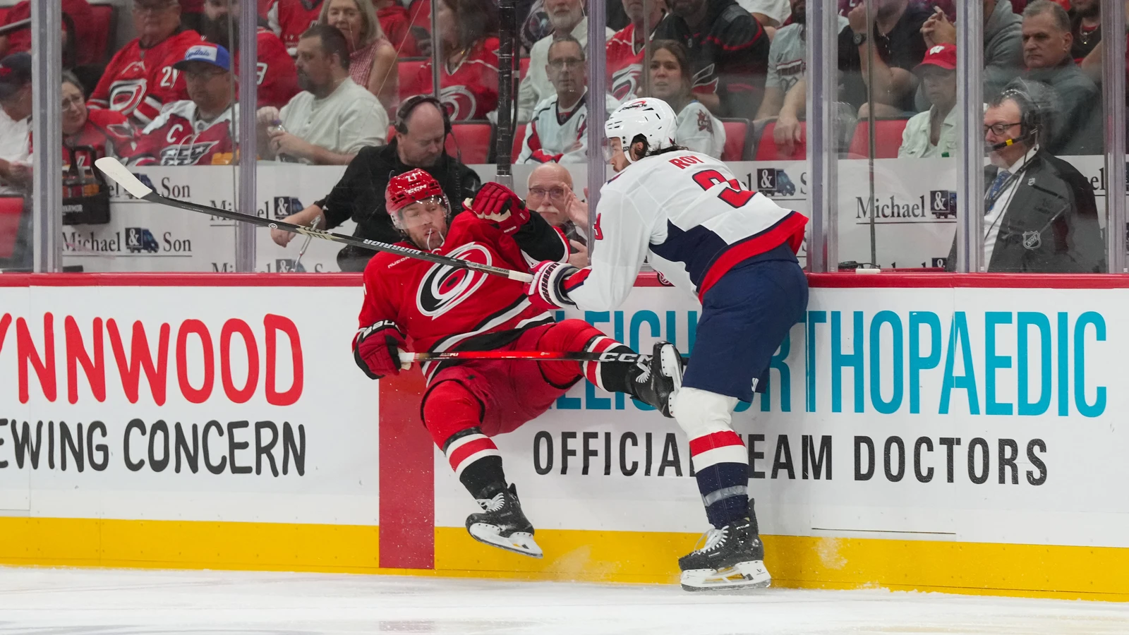 File photo: Washington Capitals defenceman Matt Roy checks a Carolina Hurricanes player along the boards.