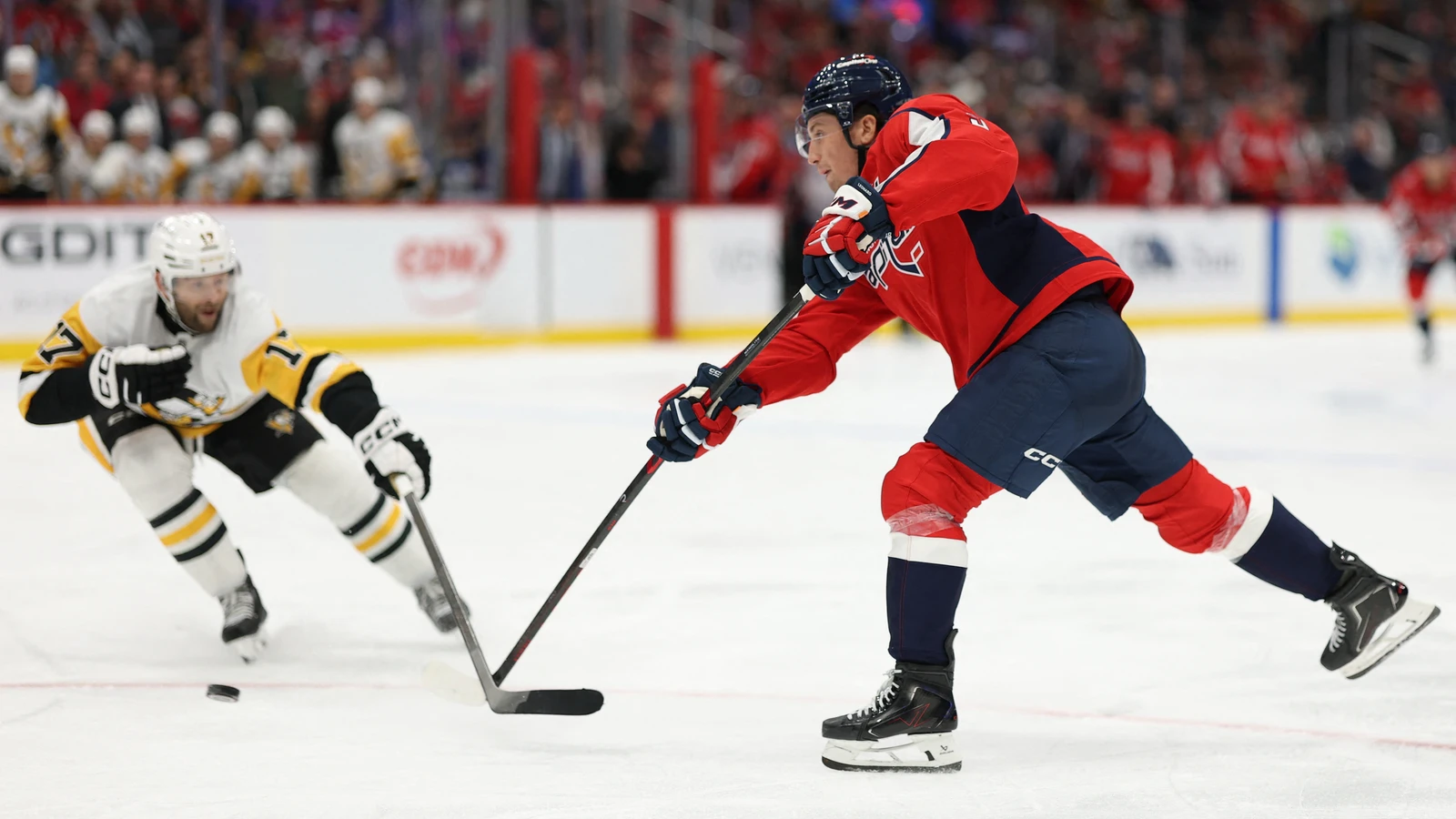 File photo: Washington Capitals forward Ryan Leonard shoots the puck as a Pittsburgh Penguins player defends at Capital One Arena.