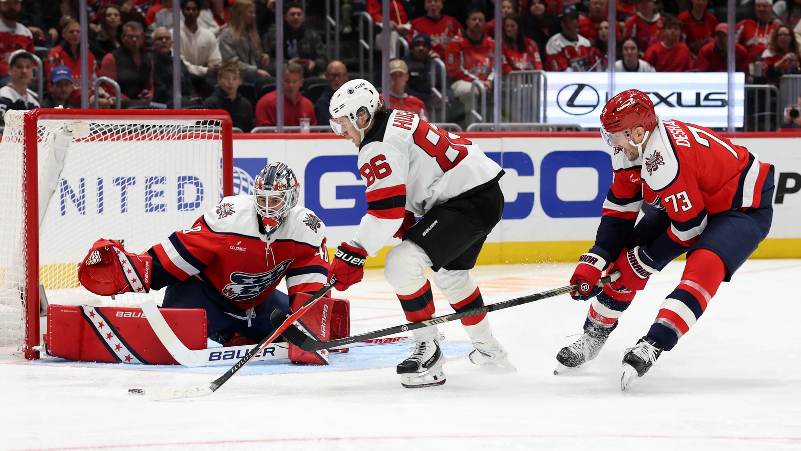 Washington Capitals goaltender Logan Thompson stretches across the crease to stop a shot against the New Jersey Devils at Capital One Arena.
