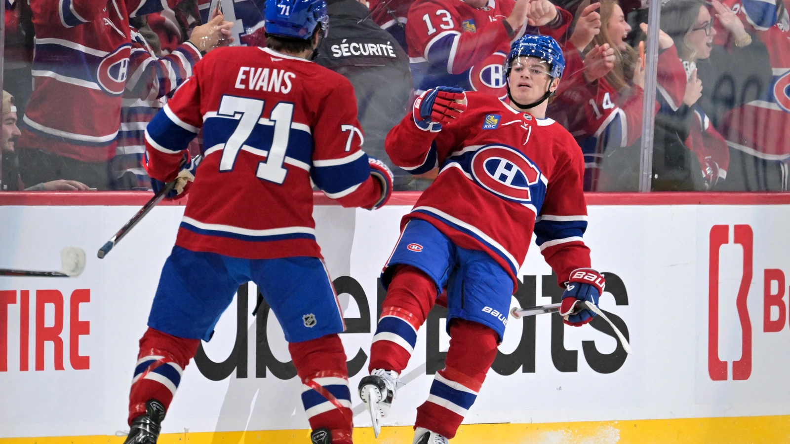 Montreal Canadiens forward Cole Caufield celebrates his overtime winner with Jake Evans against the Buffalo Sabres at Bell Centre.