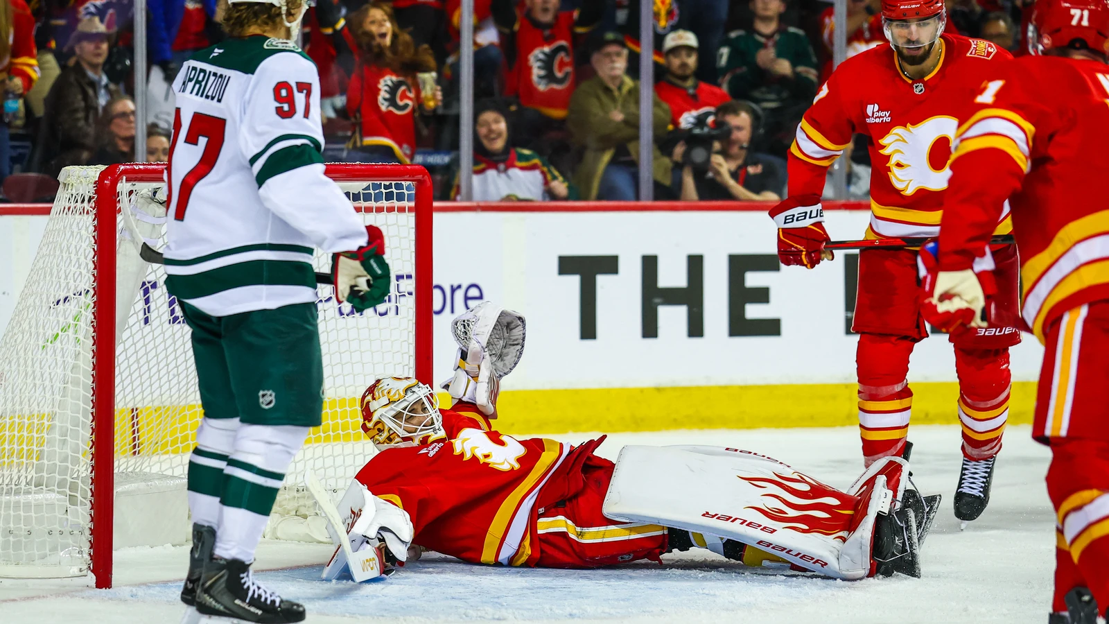 Calgary Flames goaltender Devin Cooley stretches across his crease to make a save against the Minnesota Wild.