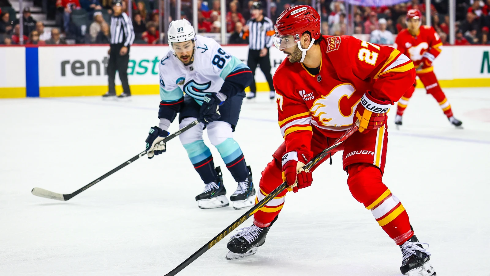 Calgary Flames right wing Matt Coronato skates with the puck against the Seattle Kraken at Scotiabank Saddledome.