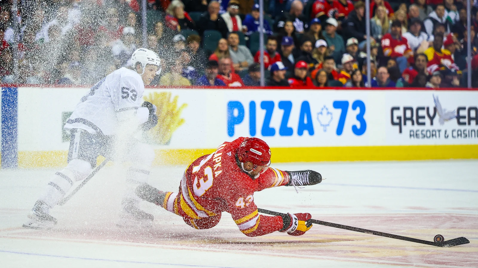 Toronto Maple Leafs forward Easton Cowan (53) challenges Calgary Flames forward Adam Klapka during the third period at Scotiabank Saddledome.