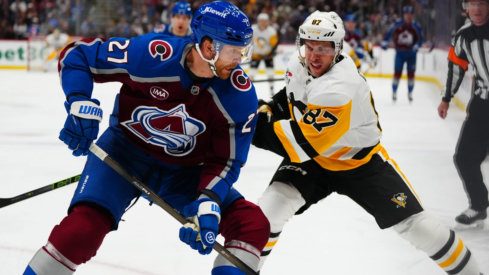 Sidney Crosby battles for the puck against Colorado Avalanche defenceman Brett Kulak at Ball Arena.
