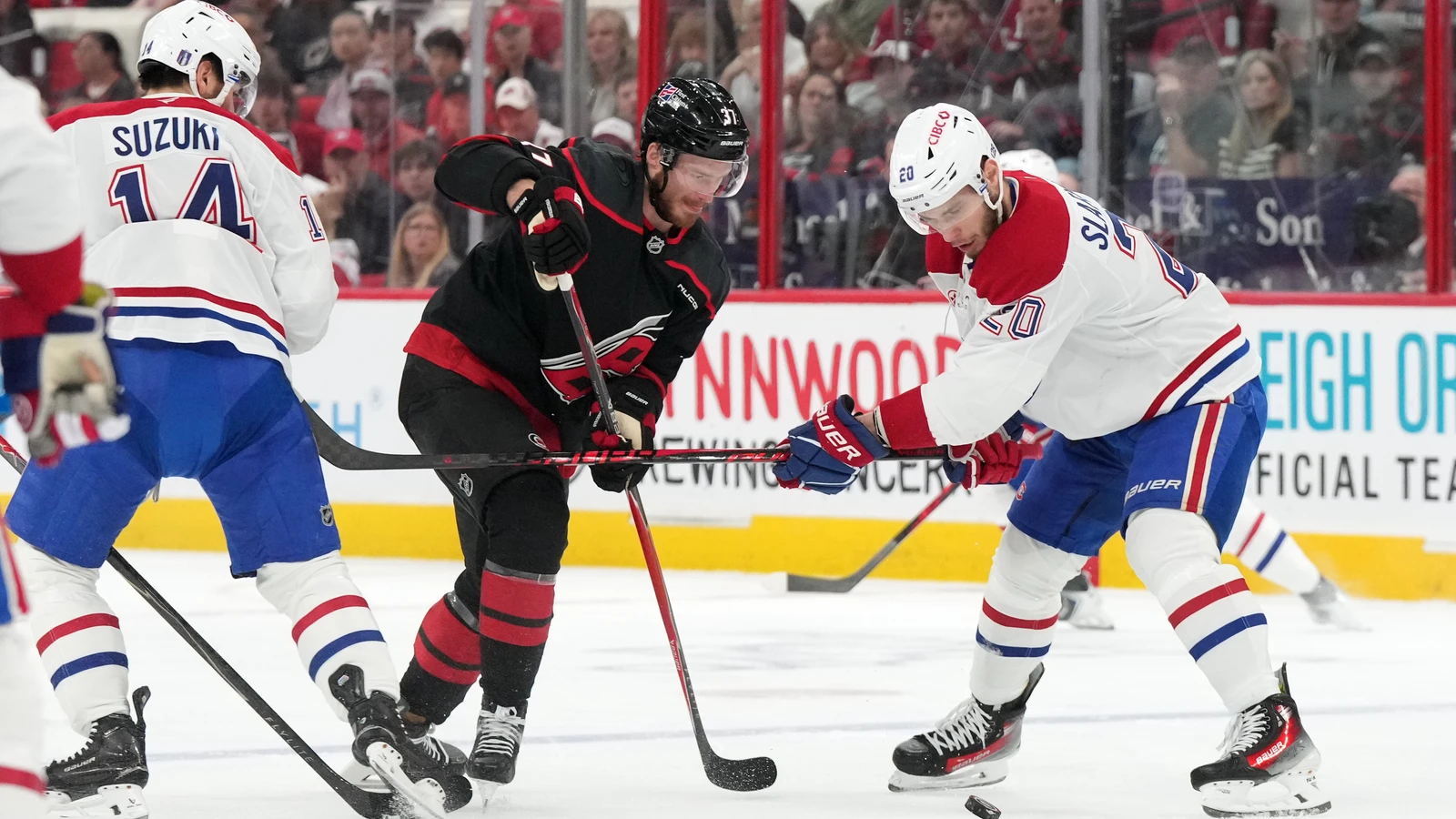 Nick Suzuki and Juraj Slafkovský defend against Andrei Svechnikov during the 2026 Eastern Conference Final. File photo.