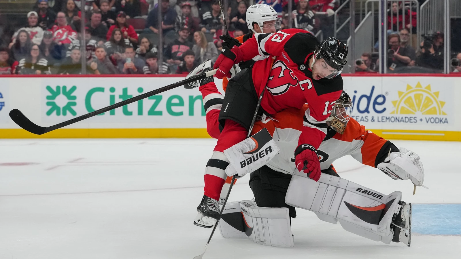 File photo: New Jersey Devils captain Nico Hischier collides with Philadelphia Flyers goaltender Joseph Woll during overtime in Newark.