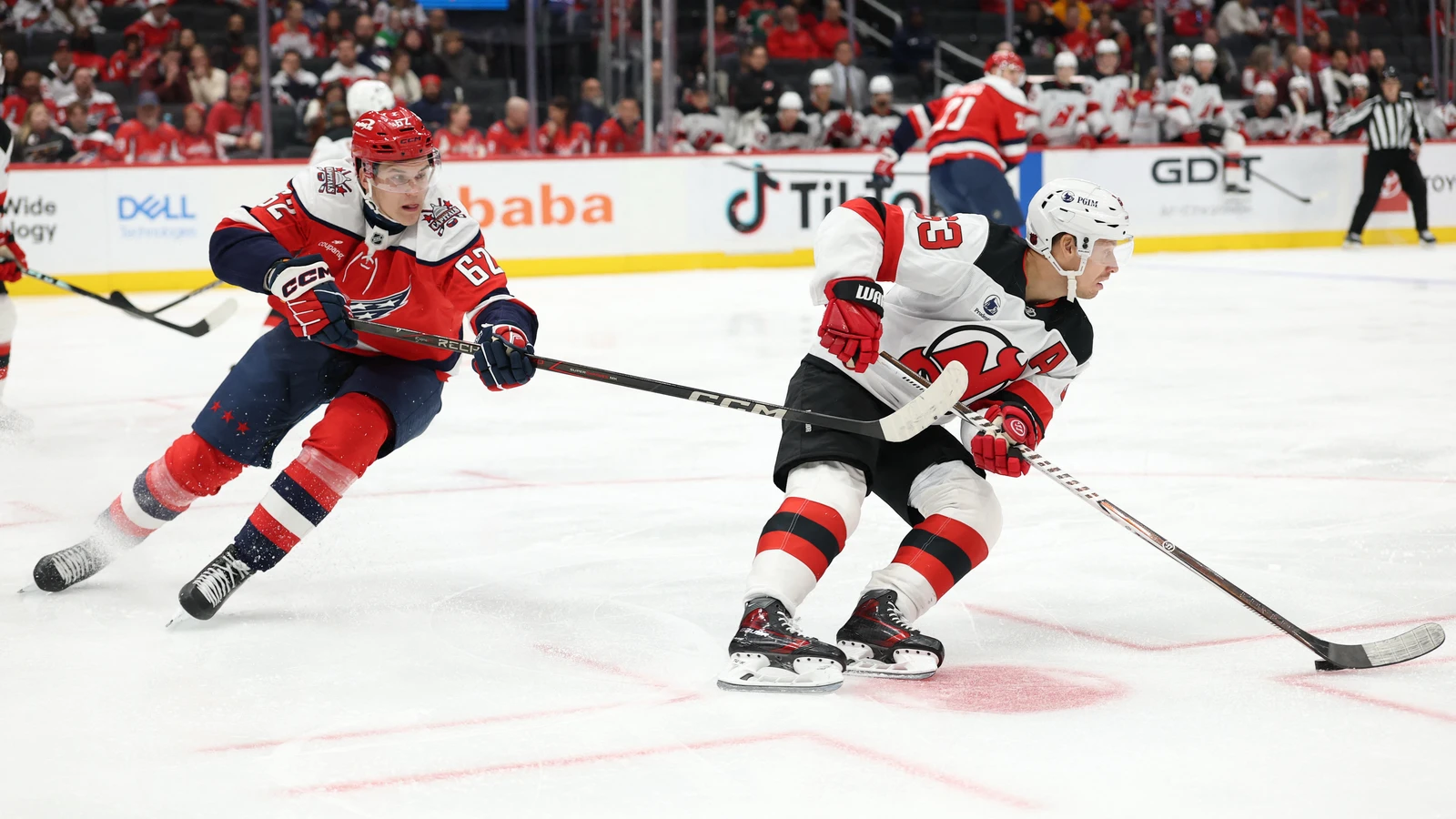 File photo: New Jersey Devils forward Jesper Bratt skates with the puck as Washington Capitals forward Ilya Protas defends.
