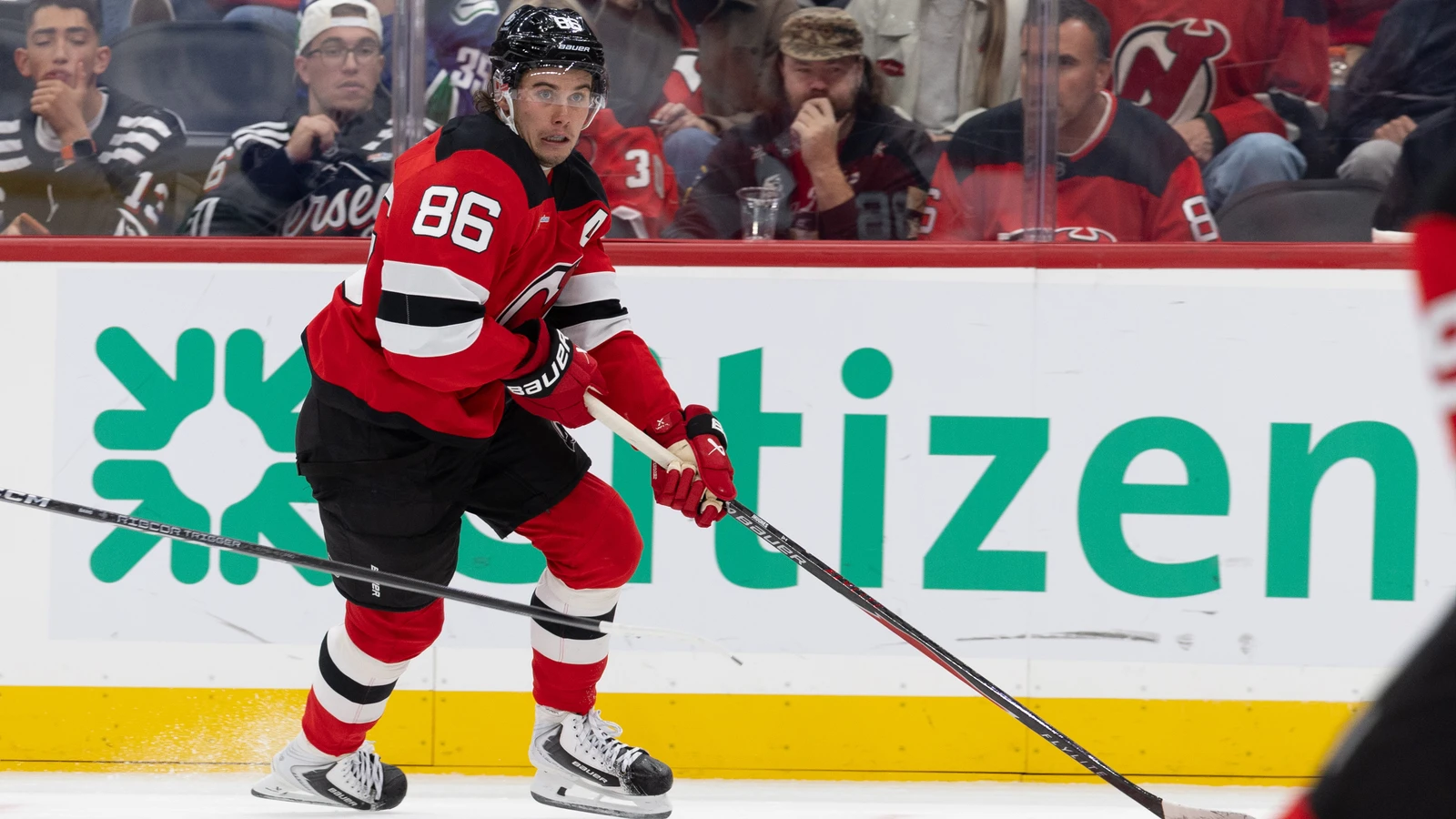 File photo: New Jersey Devils centre Jack Hughes skates with the puck against the Vancouver Canucks at Prudential Center.