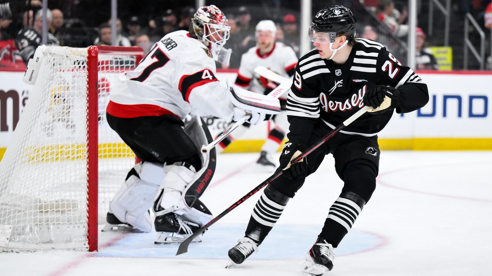 File photo: New Jersey Devils winger Lenni Hameenaho skates past the Ottawa Senators’ net during an April 12, 2026 game in Newark.