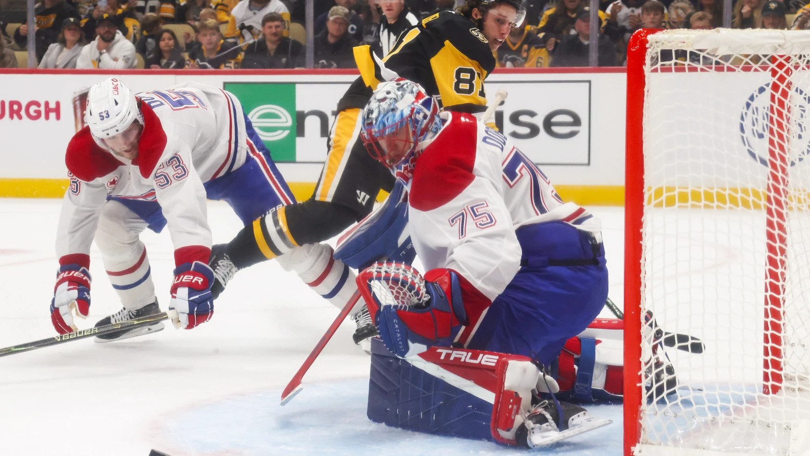 File photo: Montreal Canadiens goaltender Jakub Dobes makes a save beside his net against the Pittsburgh Penguins.