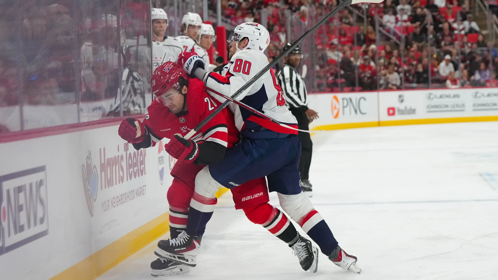 File photo: Washington Capitals centre Pierre-Luc Dubois checks Carolina Hurricanes defenceman Sean Walker along the boards in Raleigh.