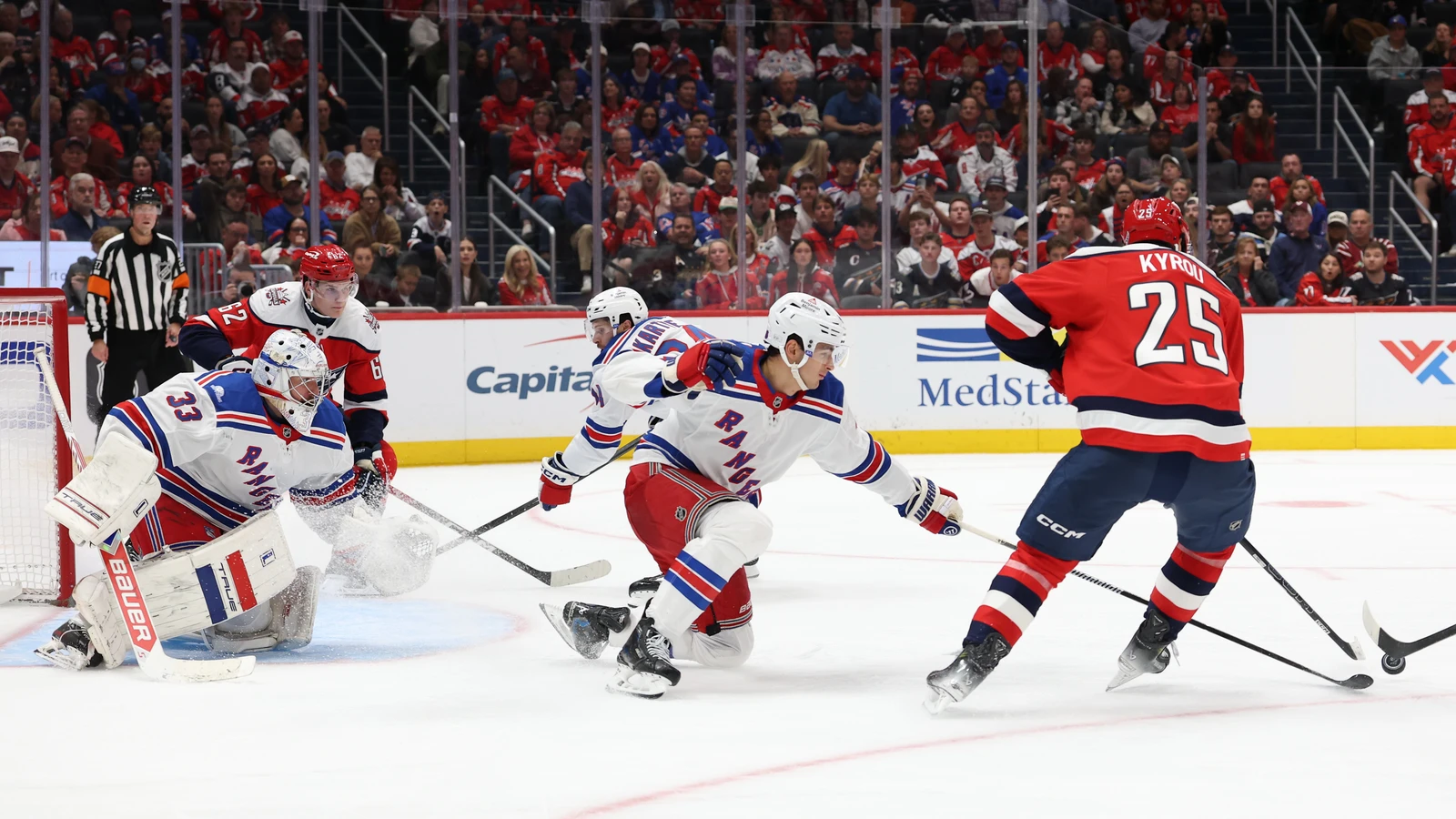 File photo: New York Rangers goaltender Dylan Garand guards his net as Washington Capitals forward Jordan Kyrou carries the puck.