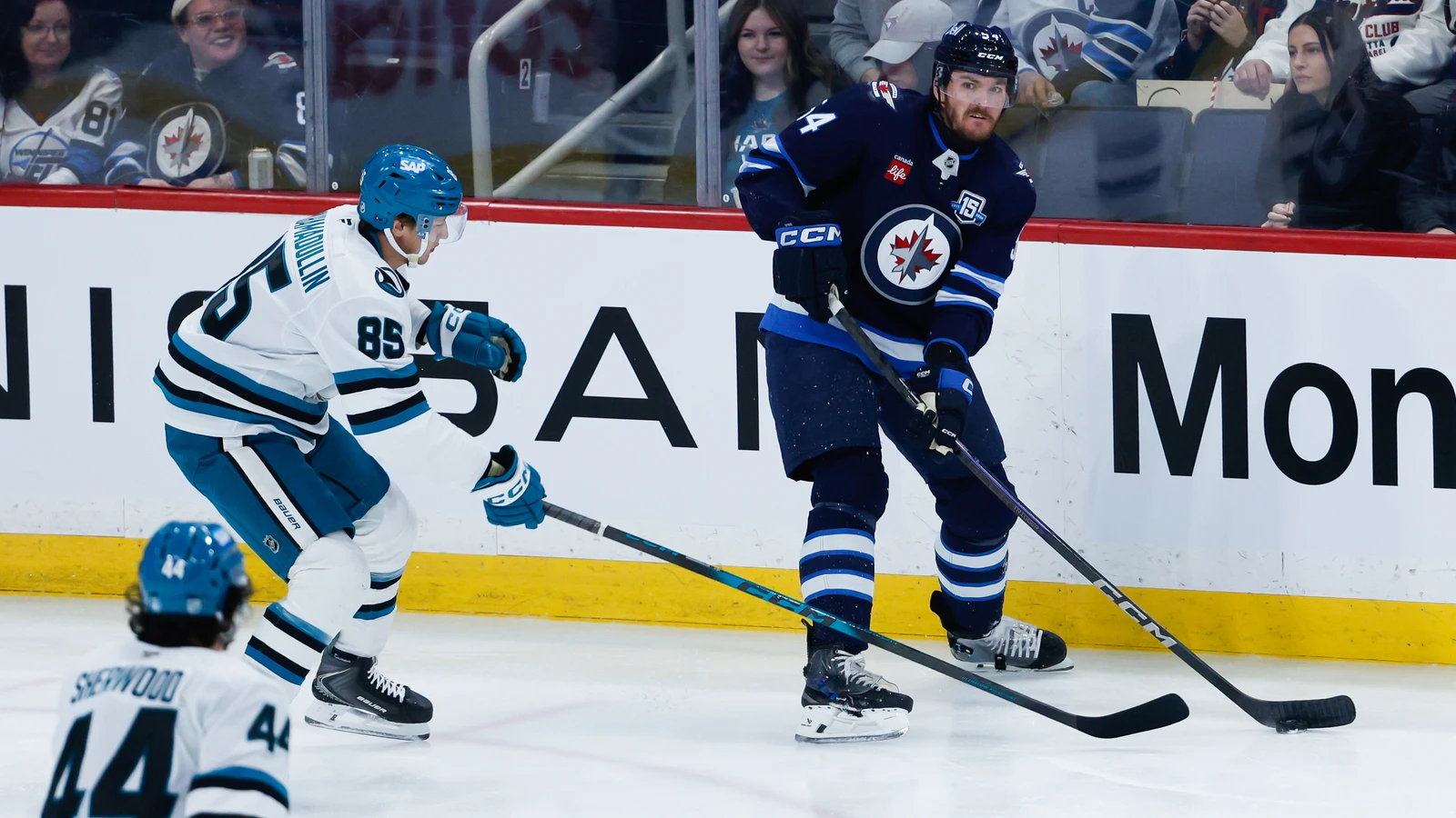 Dylan Samberg looks to pass the puck for Winnipeg against San Jose in April 2026. File photo.