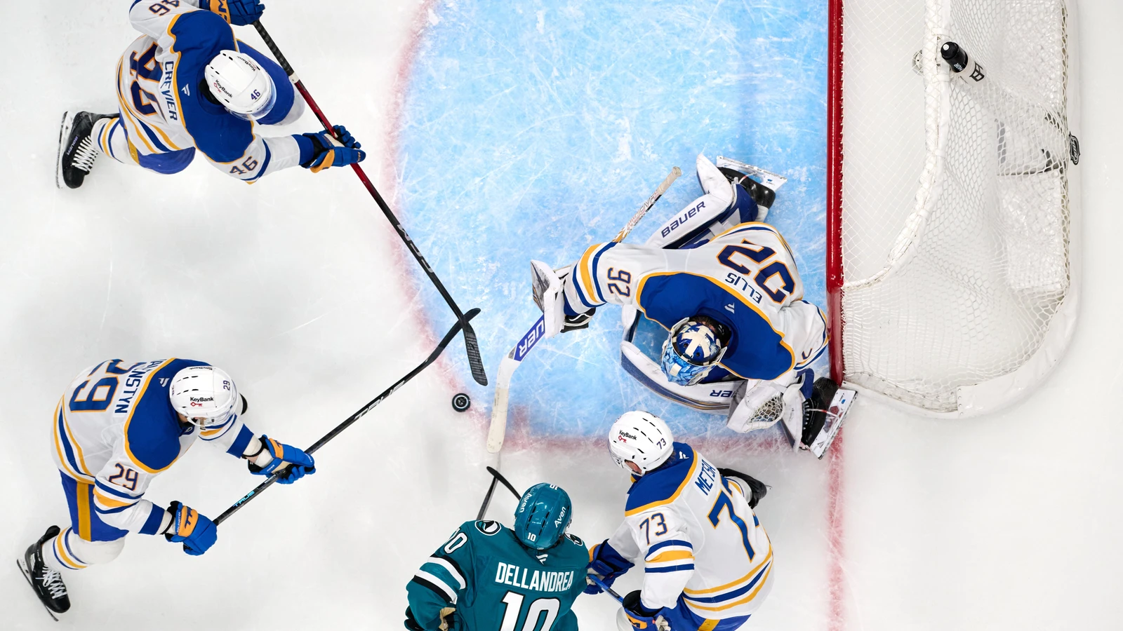 Buffalo Sabres goaltender Colten Ellis tracks the puck in his crease against the San Jose Sharks.