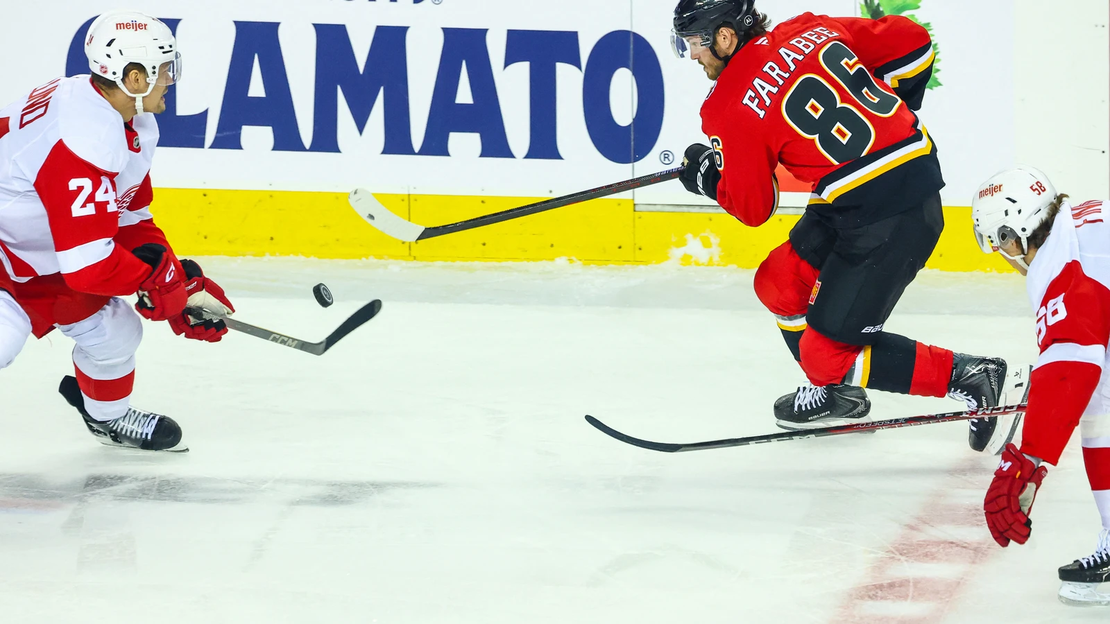 Calgary Flames forward Joel Farabee plays the puck against the Detroit Red Wings at Scotiabank Saddledome.