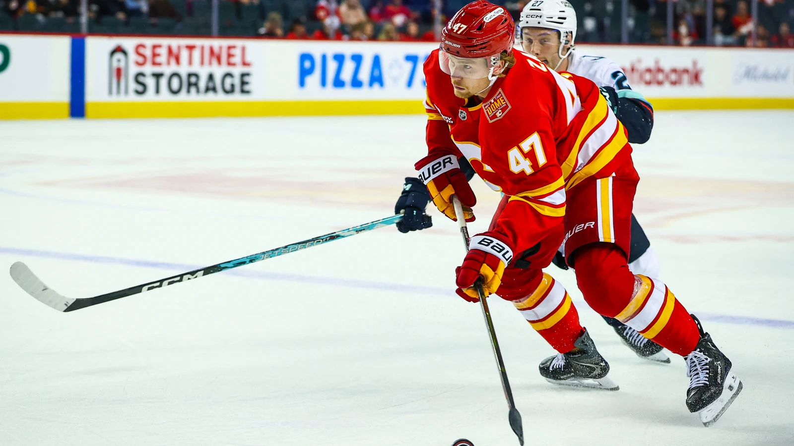 File photo: Calgary Flames forward Connor Zary controls the puck against the Seattle Kraken at Scotiabank Saddledome.
