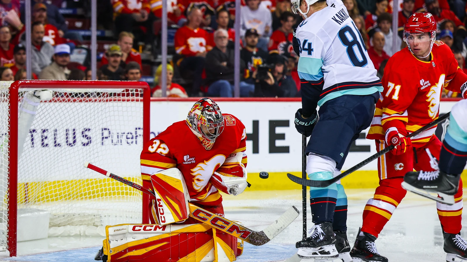 File photo: Calgary Flames goaltender Dustin Wolf makes a save against Seattle Kraken forward Kaapo Kakko at Scotiabank Saddledome.