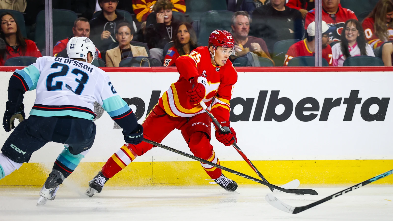 File photo: Calgary Flames forward William Stromgren controls the puck against Seattle Kraken defenceman Gustav Olofsson at Scotiabank Saddledome.