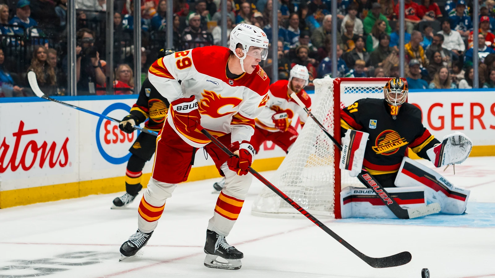 File photo: Calgary Flames forward Samuel Honzek handles the puck against the Vancouver Canucks at Rogers Arena.