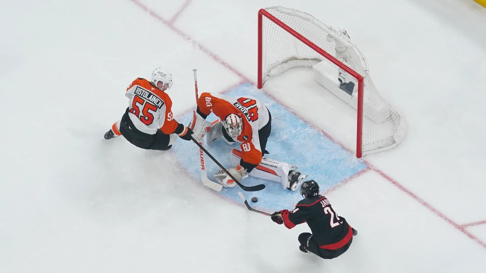 Rasmus Ristolainen defends Philadelphia's net with Dan Vladar as Seth Jarvis shoots for Carolina on May 4, 2026. File photo.