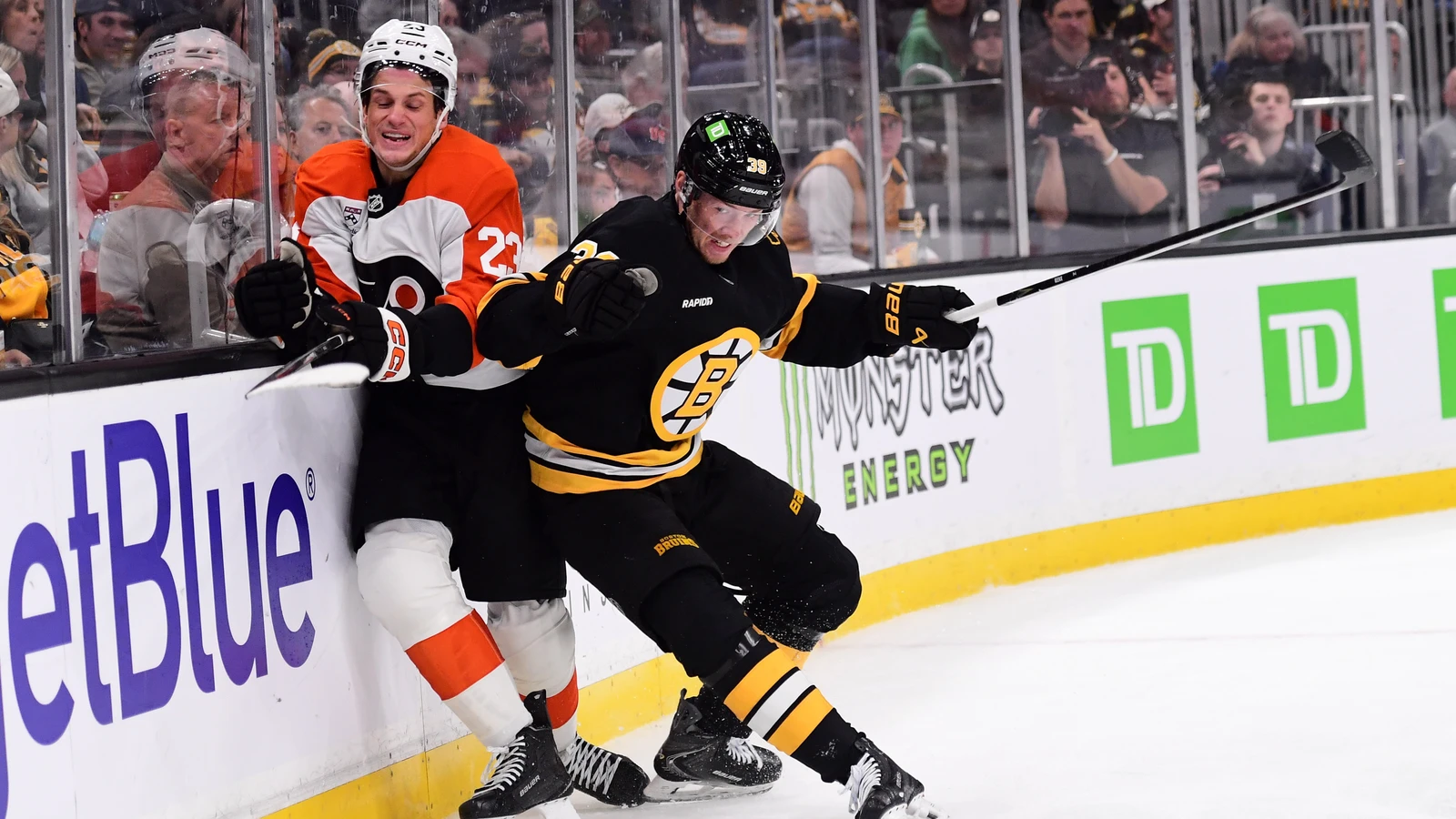 File photo: Philadelphia Flyers forward Jack Studnicka is checked by Boston Bruins centre Morgan Geekie against the boards at TD Garden.