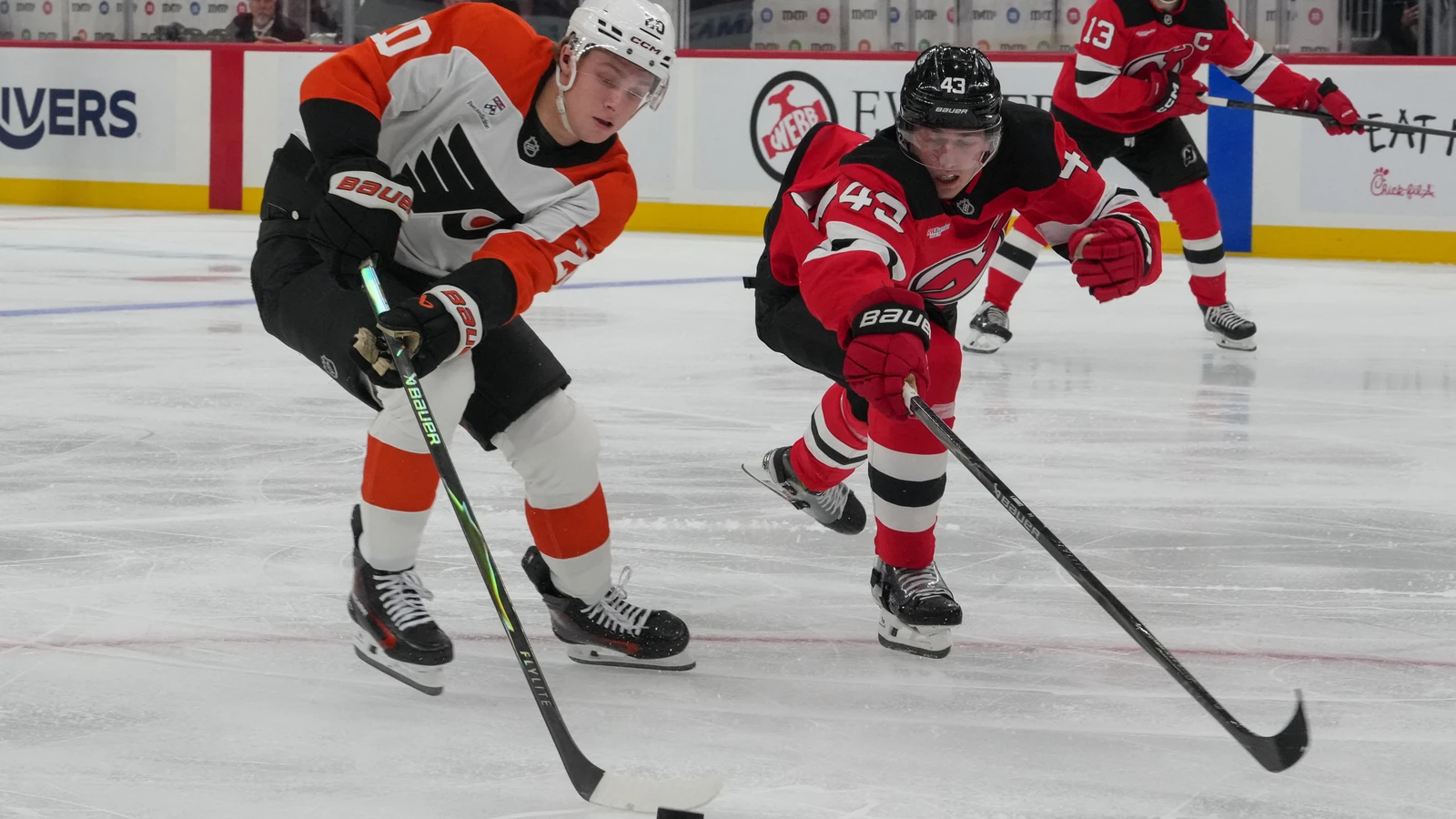 File photo: Philadelphia Flyers winger Alex Bump plays the puck against the New Jersey Devils at Prudential Center.