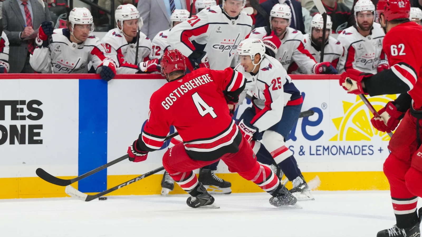 File photo: Shayne Gostisbehere chases the puck along the boards during a Carolina Hurricanes game against Washington.