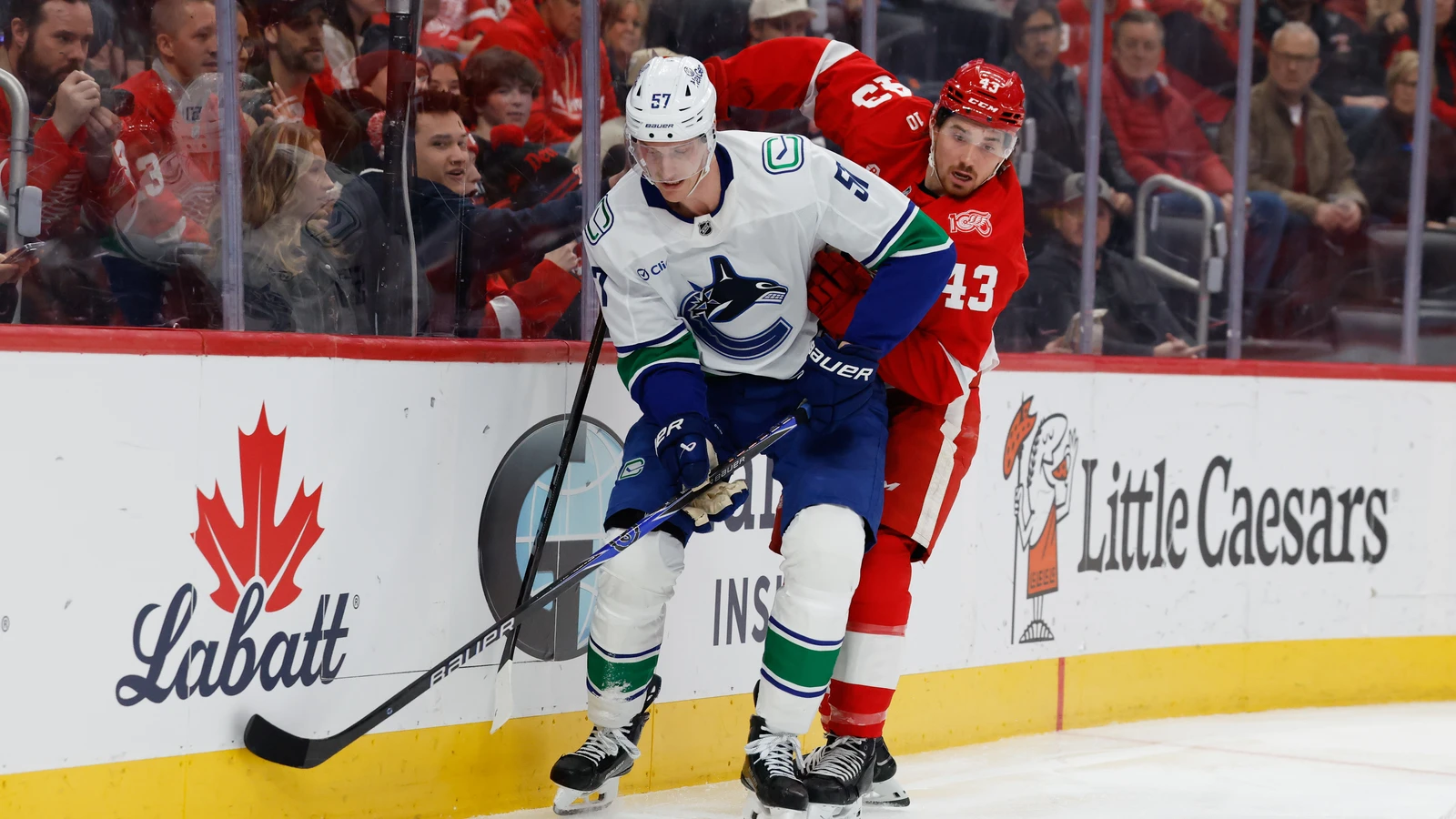 John Leonard of Detroit battles Vancouver defenseman Tyler Myers for the puck on Jan. 8, 2026. File photo.