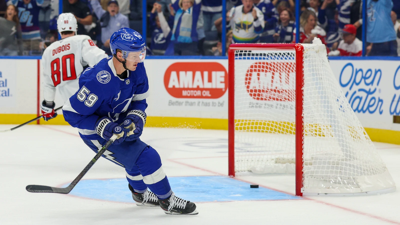 Jake Guentzel of the Tampa Bay Lightning skates beside the empty Washington Capitals net after scoring.
