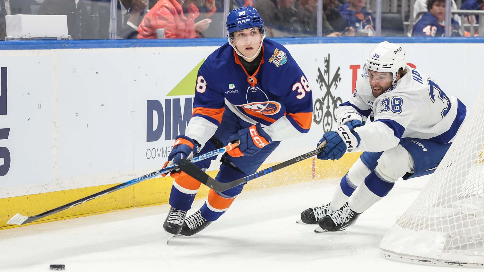 Brandon Hagel of the Tampa Bay Lightning battles for the puck beside the Islanders net at UBS Arena.