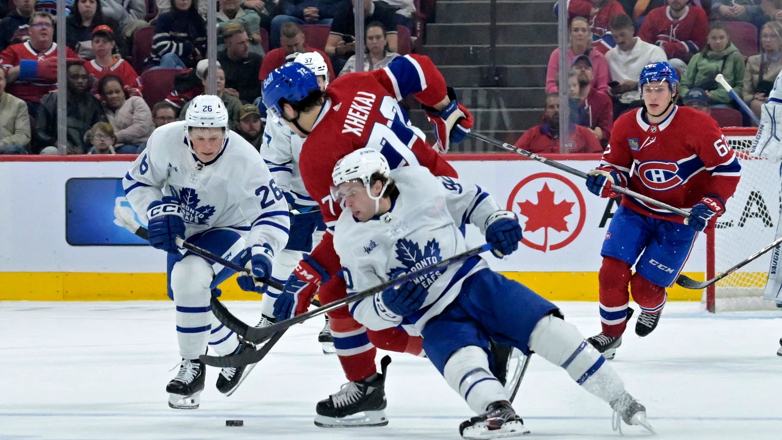 Toronto Maple Leafs forward Max Ellis battles Montreal Canadiens defenseman Arber Xhekaj for the puck during an NHL preseason game in Montreal on September 29, 2023. File photo.